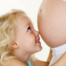 Child Holding her Mommy's Tummy