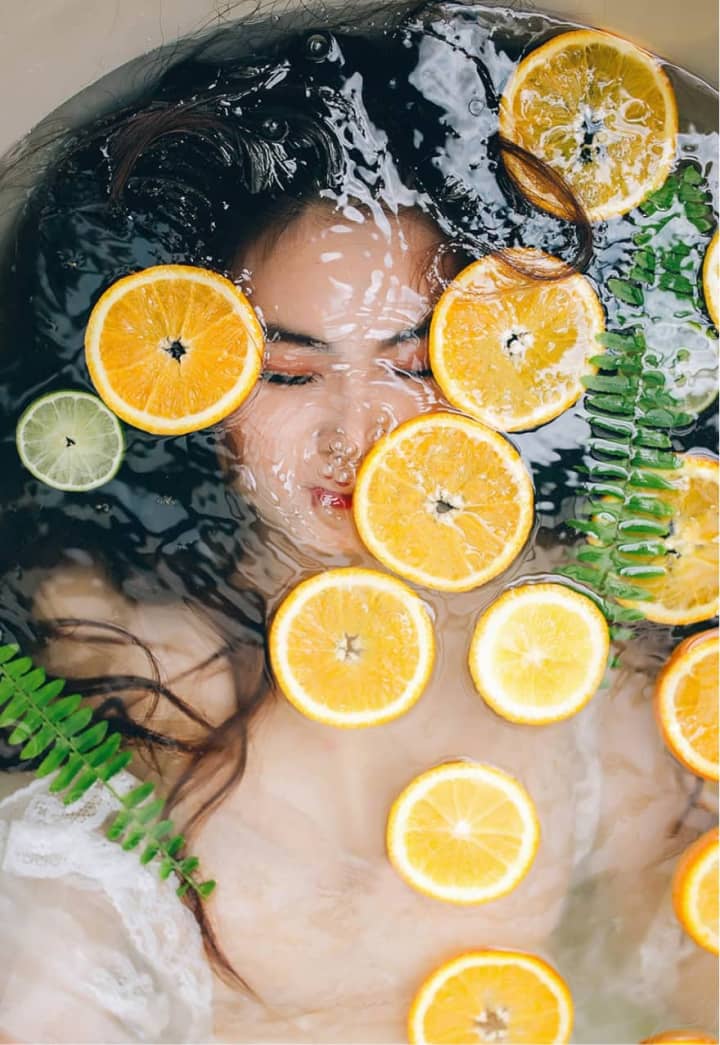 Woman Laying in Bath with Orange Slices